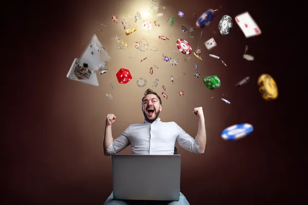 A woman smiling while playing online games on her laptop, surrounded by neon casino elements, showcasing BETPH7’s diverse game collection.