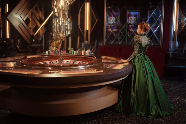 A man celebrating a winning moment on his laptop while gaming symbols float around him, capturing the excitement of BETPH7 games.